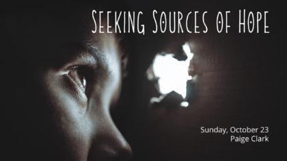A child looks through a hole at light on the other side